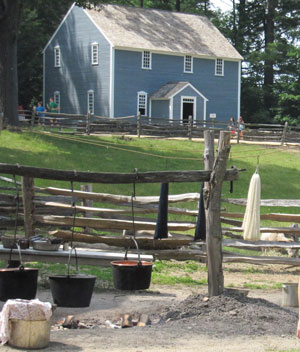 The Quaker meetinghouse overlooks the common area where wool dyeing takes place. A sheep pasture forms the front yard and sits near the main street. 